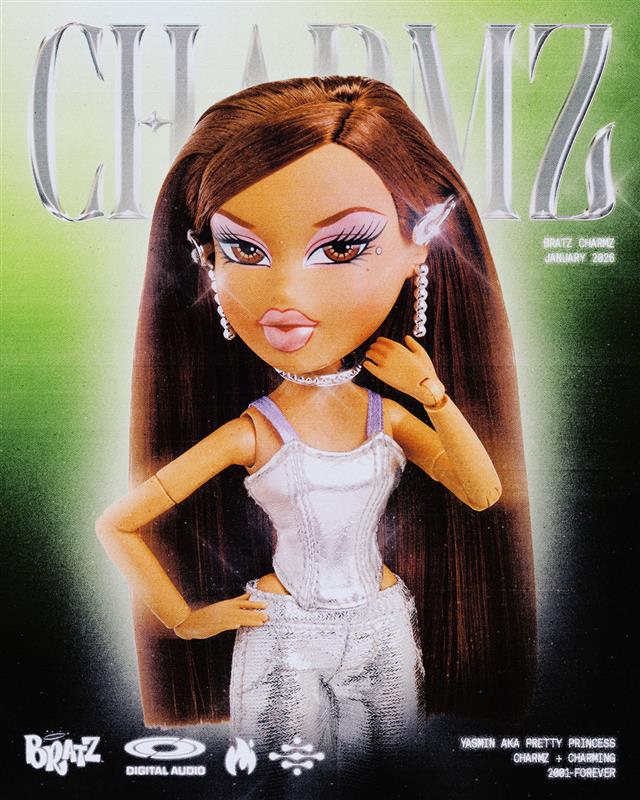 Charmz yasmin doll with long brown hair and white outfit on a green background