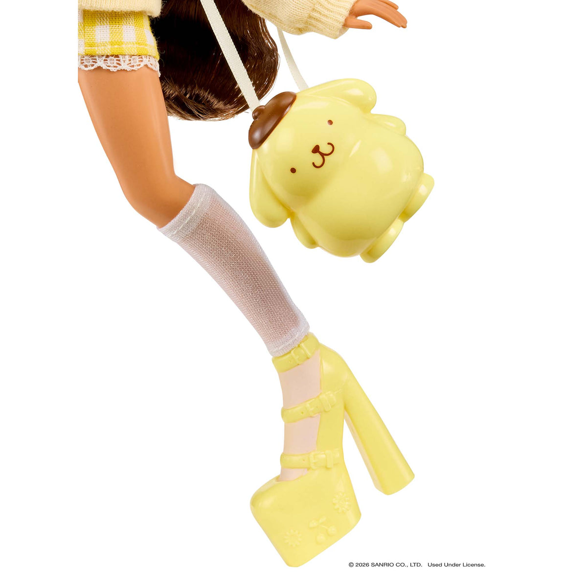 A close-up of a doll's  white thigh-high socks, and yellow high heels, while carrying a yellow plush dog-shaped shoulder bag with a brown ear.