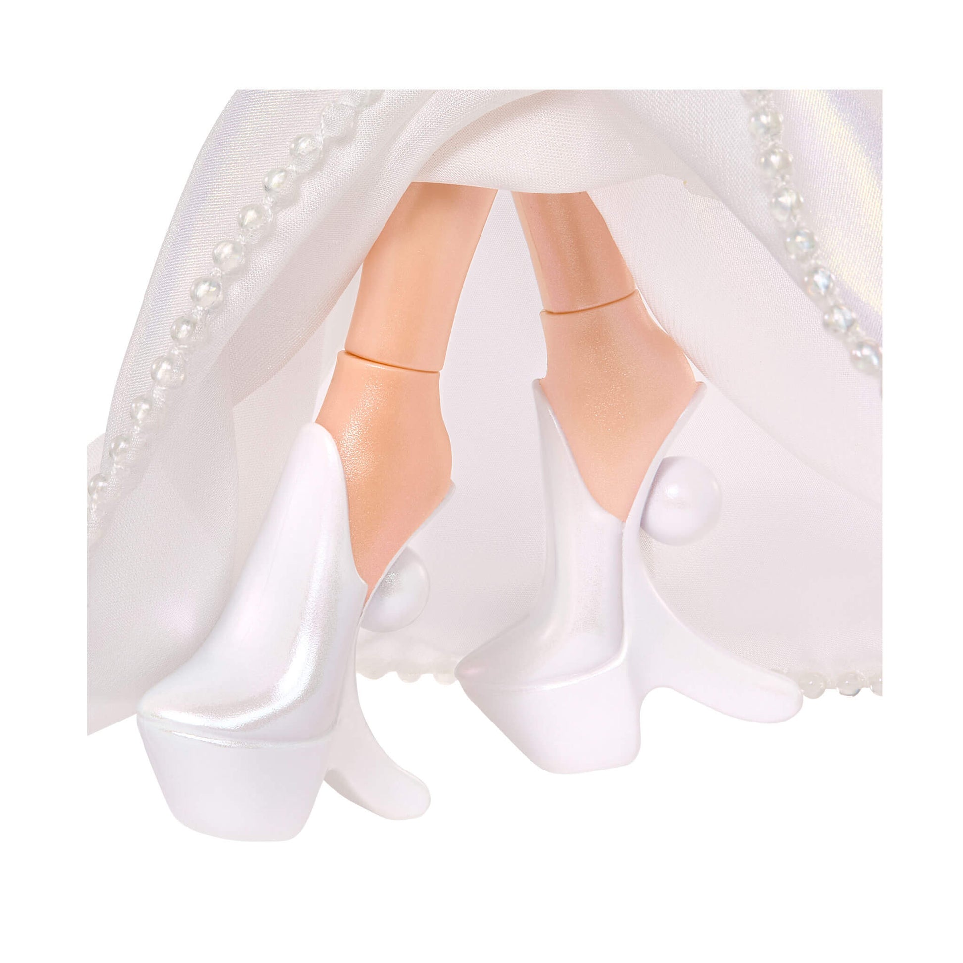 Close-up of a doll in a white dress with pearl details on a white background