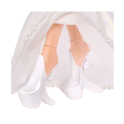 Close-up of a doll in a white dress with pearl details on a white background