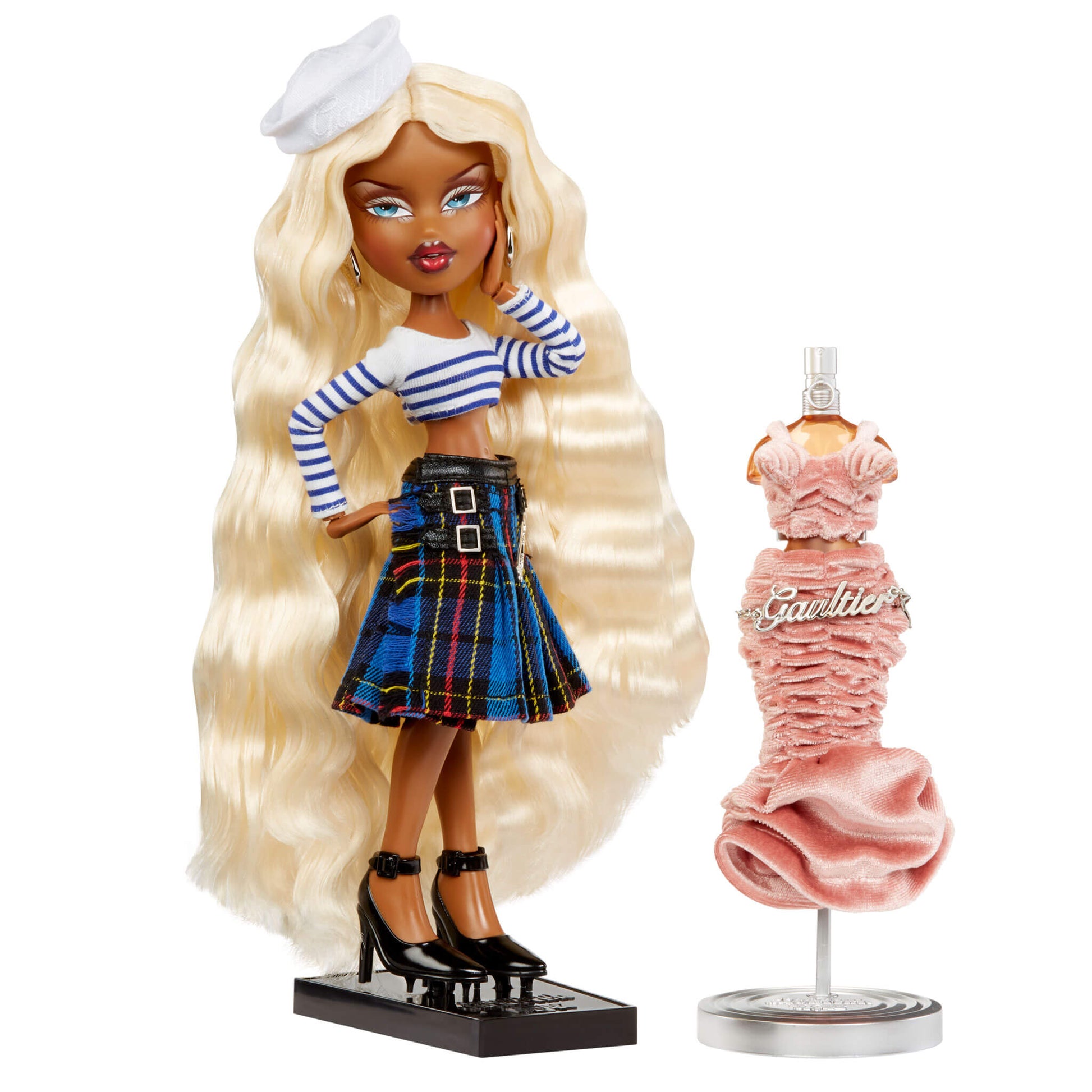 doll on doll stand  next to pink dress on stand