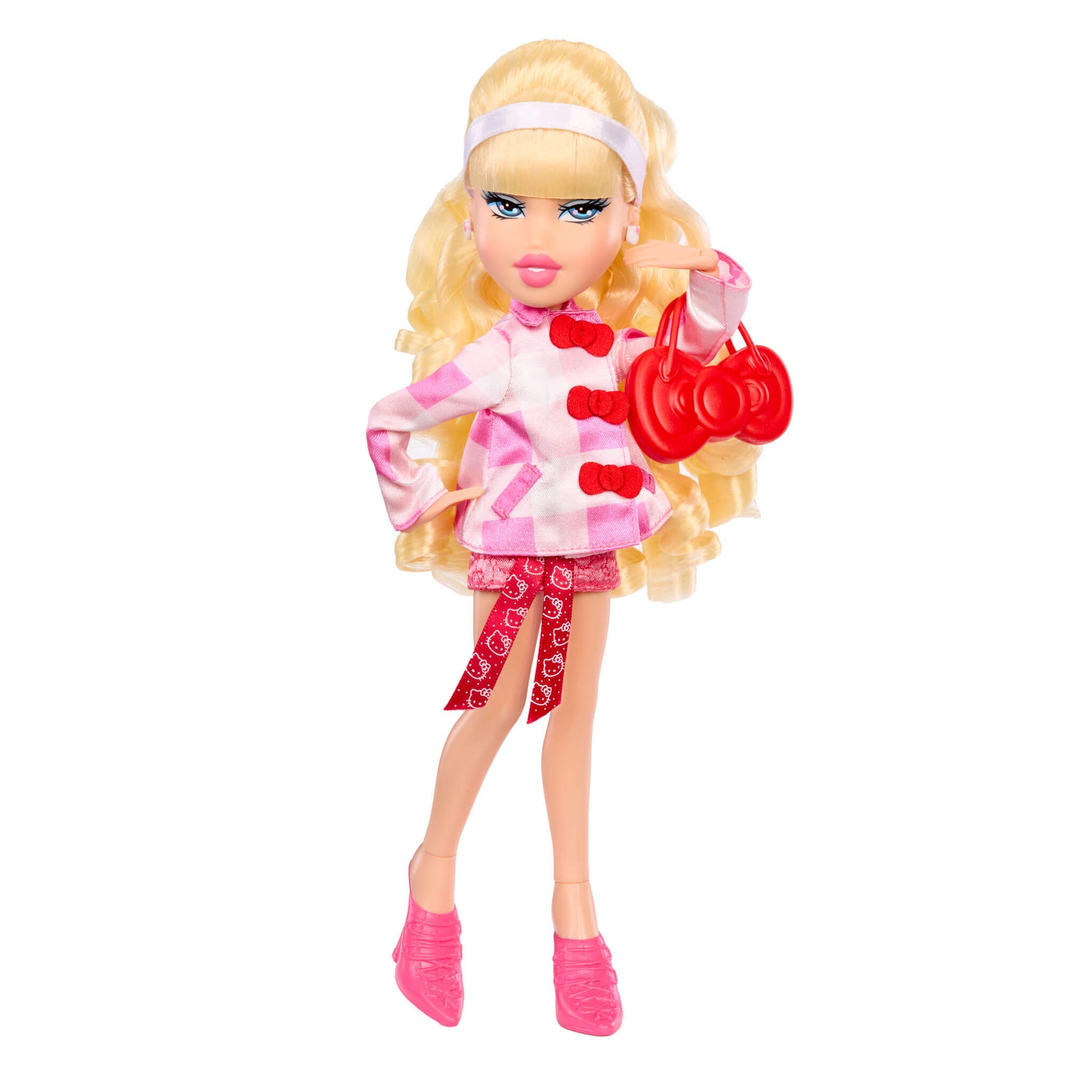 Toy doll with blonde hair, pink outfit, and red shoes on a white background