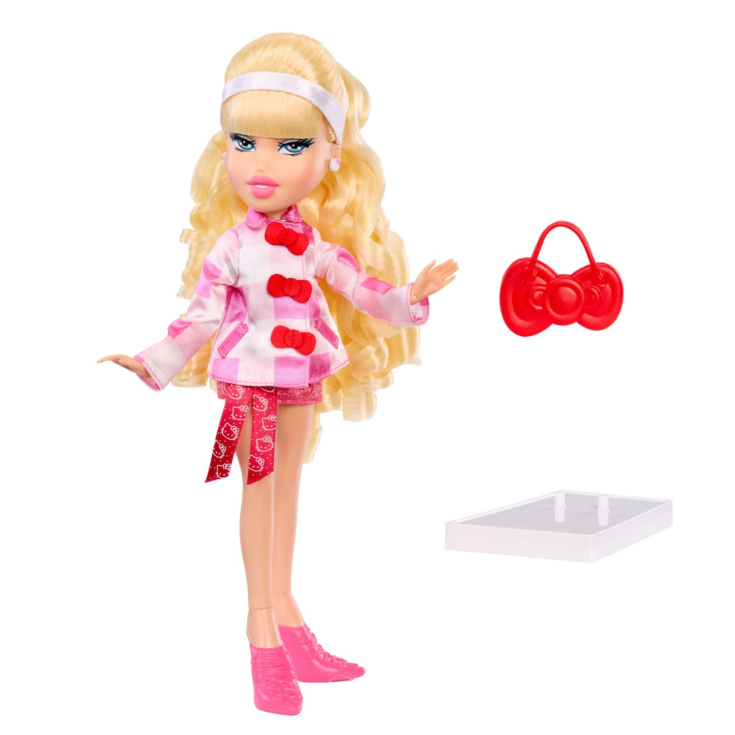 Toy doll with blonde hair and pink outfit next to a red bow-shaped bag on a white background