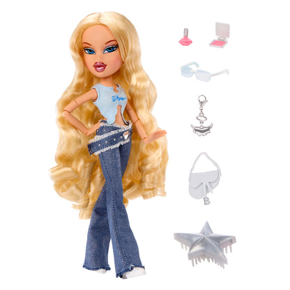 Cloe blonde fashion doll with long wavy hair, shown standing next to accessories including a pink lip gloss, compact, white sunglasses, silver keychain, white handbag, and silver star-shaped accessory