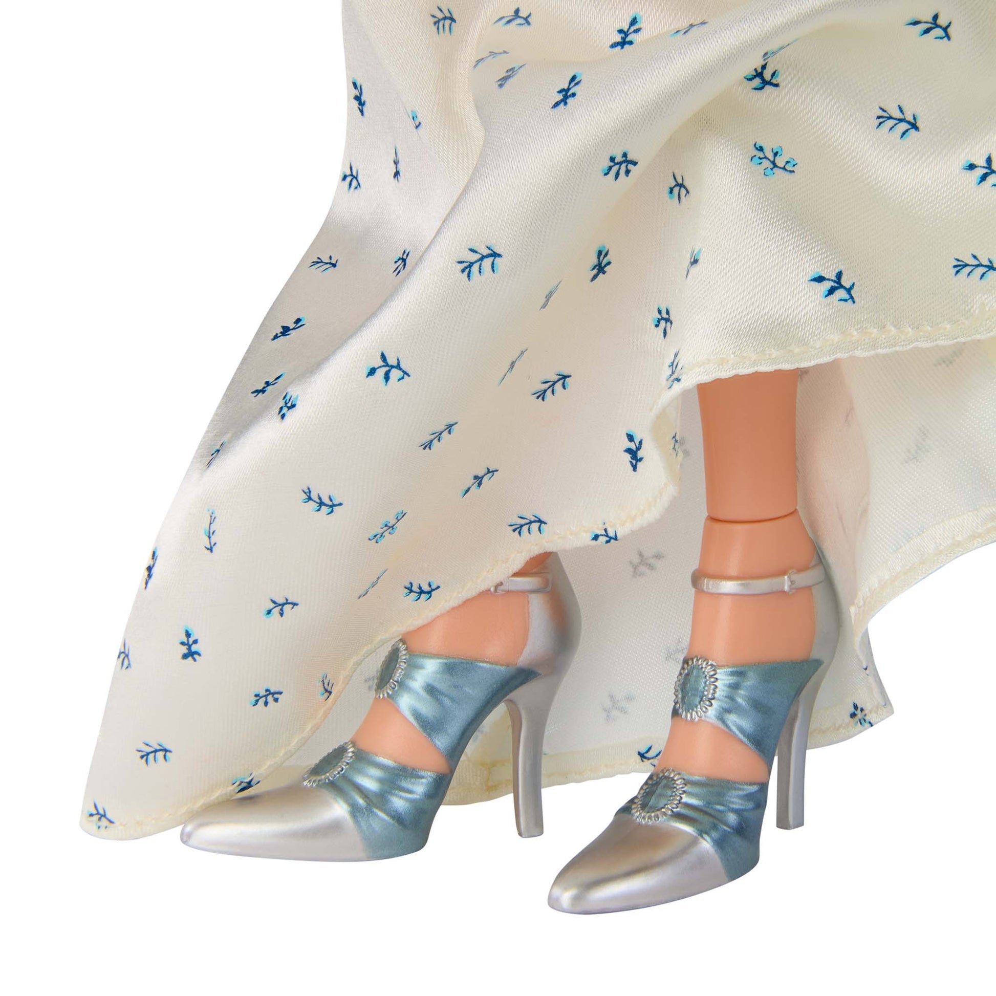 Close-up of a doll wearing silver blue shoes 