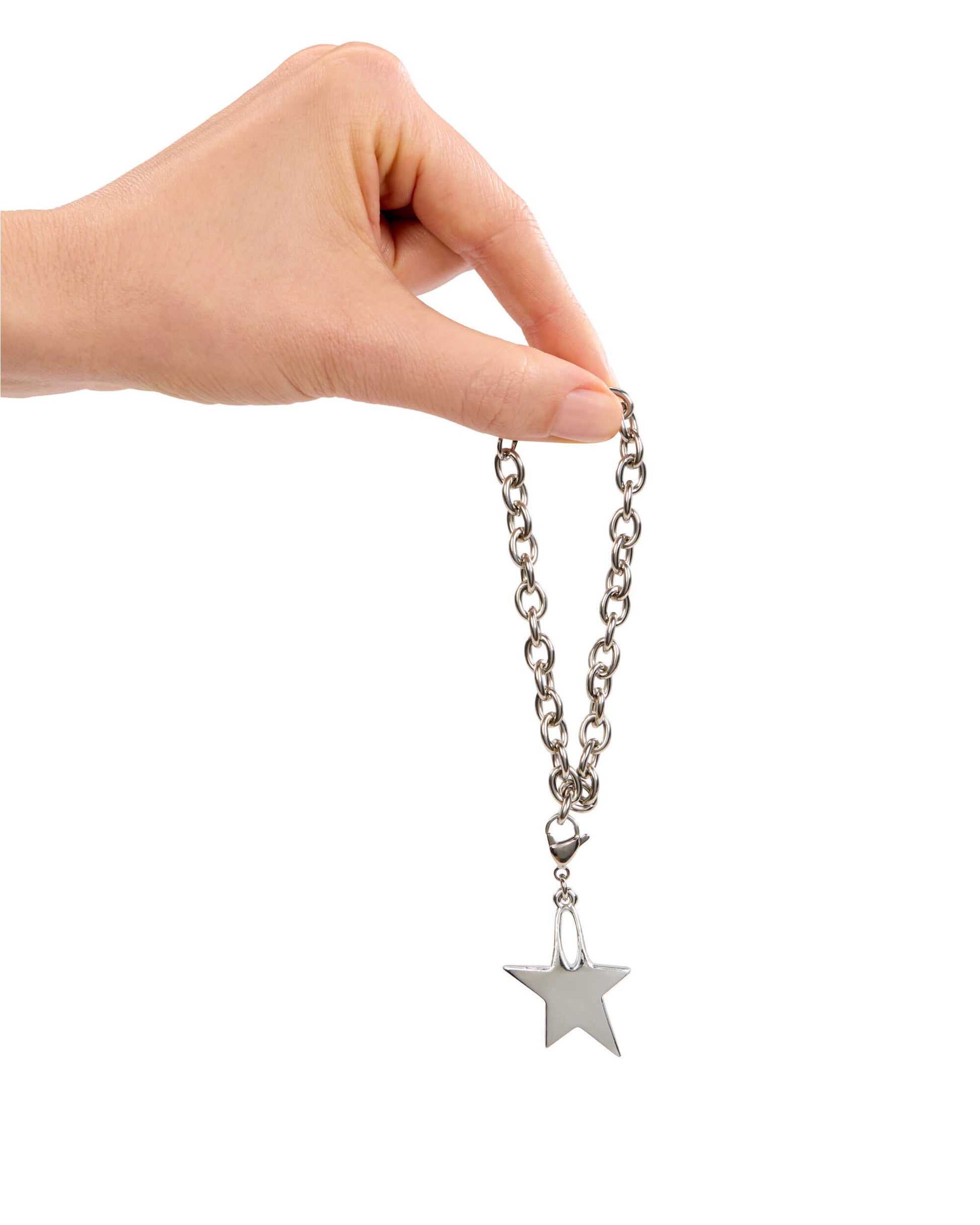 Hand holding a silver chain with a star charm on a white background