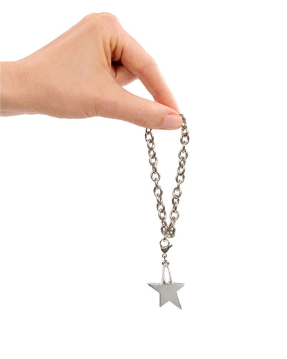 Hand holding a silver chain with a star charm on a white background