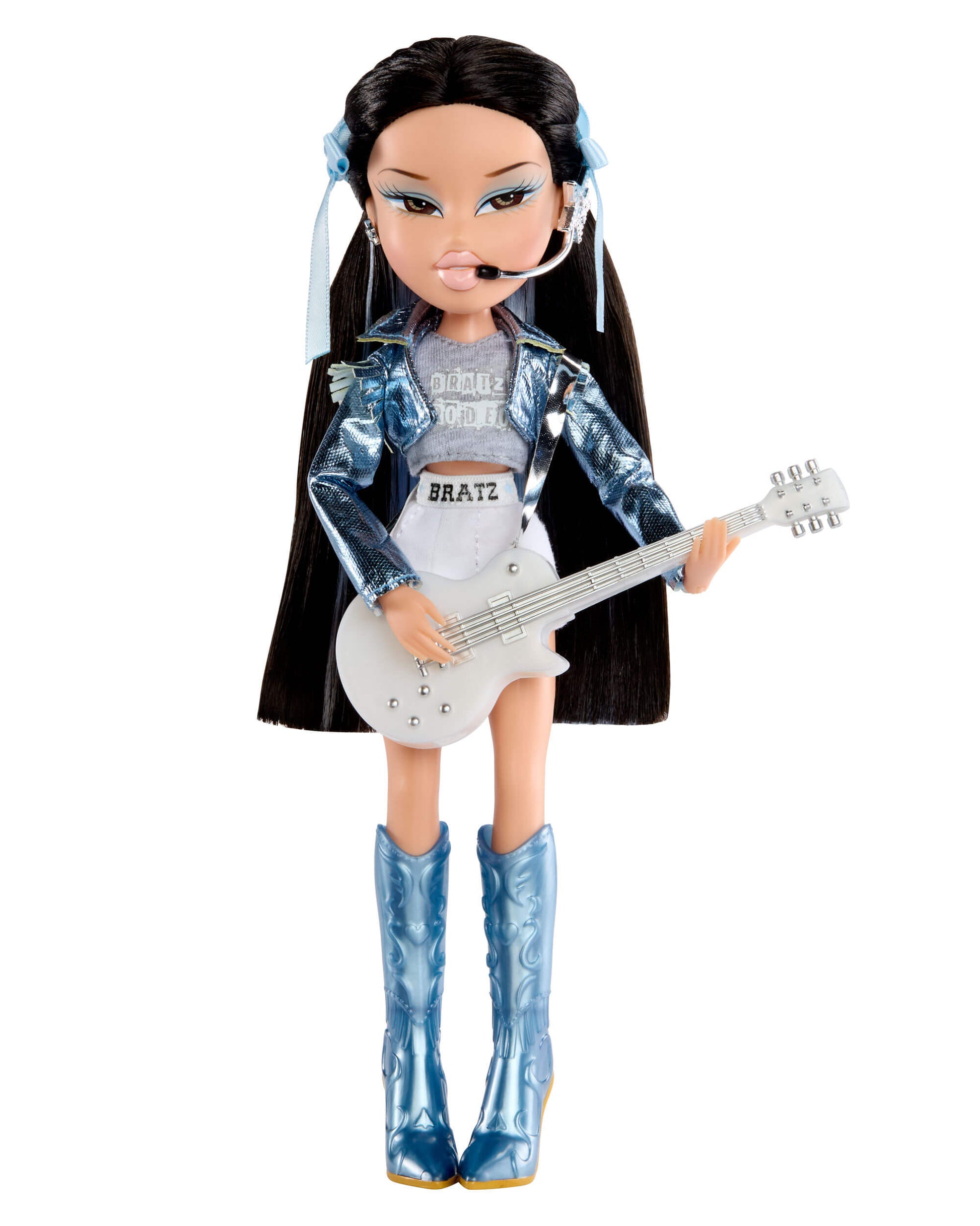 Jade with long dark hair, blue boots, and a guitar on a white background