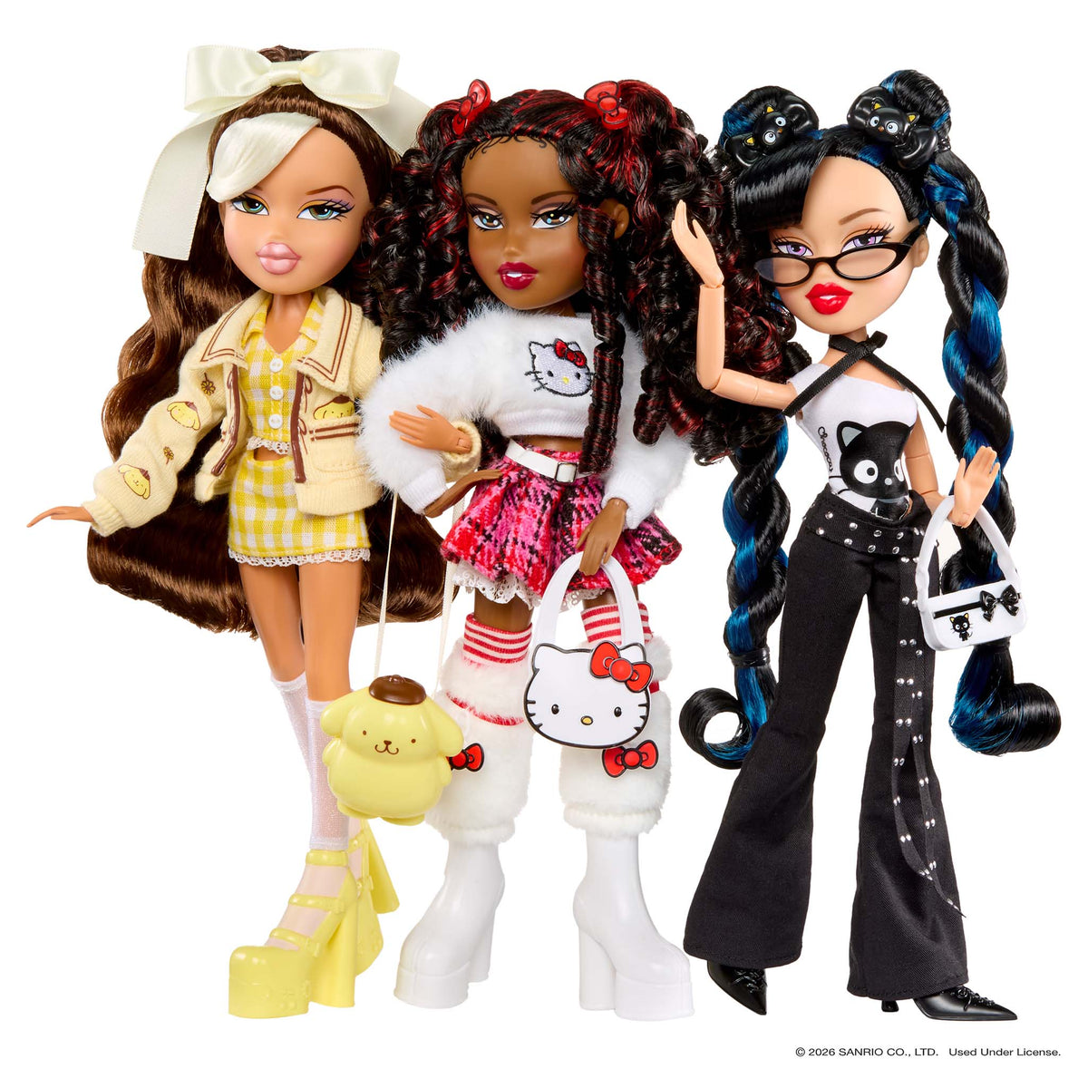 Three fashion dolls standing together on a white background, each styled with different outfits and accessories. The doll on the left has long brown hair, a white bow, a beige jacket, a yellow-and-white dress, white socks, and yellow platform shoes, and carries a yellow plush bag.